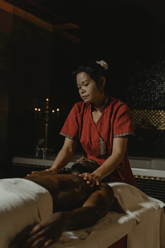 Experience a calming massage from an expert masseuse in a dimly lit spa for total relaxation.