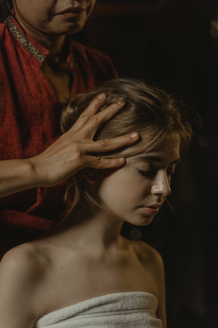 A soothing head massage promoting relaxation and wellness, captured in a peaceful setting.
